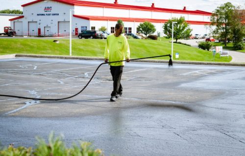 worker sealcoating asphalt